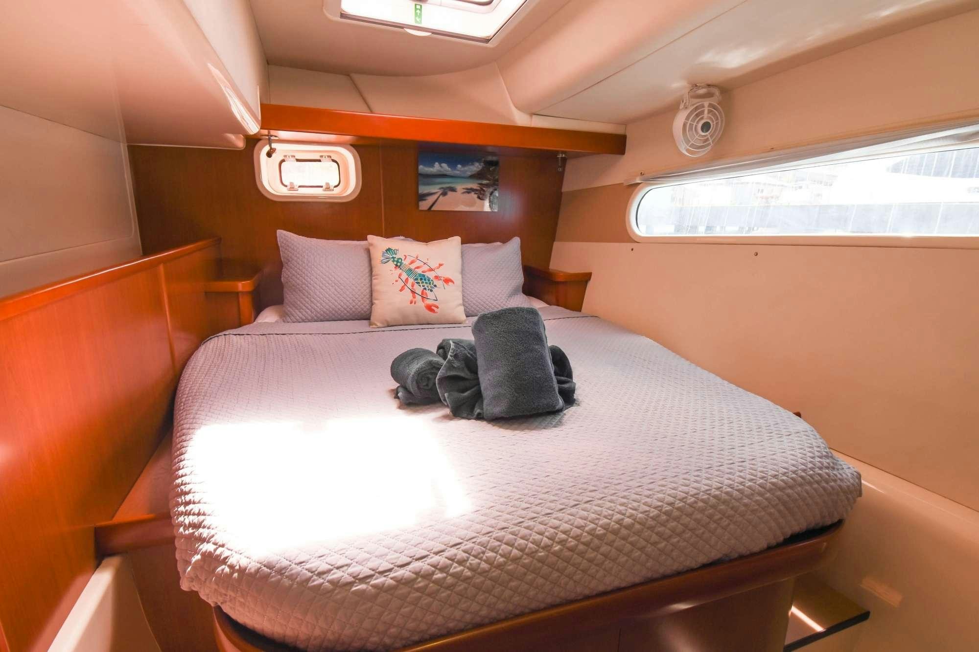 a bed with pillows on it aboard DEEPBLUE Yacht for Charter