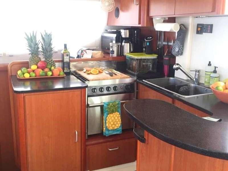 a kitchen with a stove and a sink aboard DEEPBLUE Yacht for Charter
