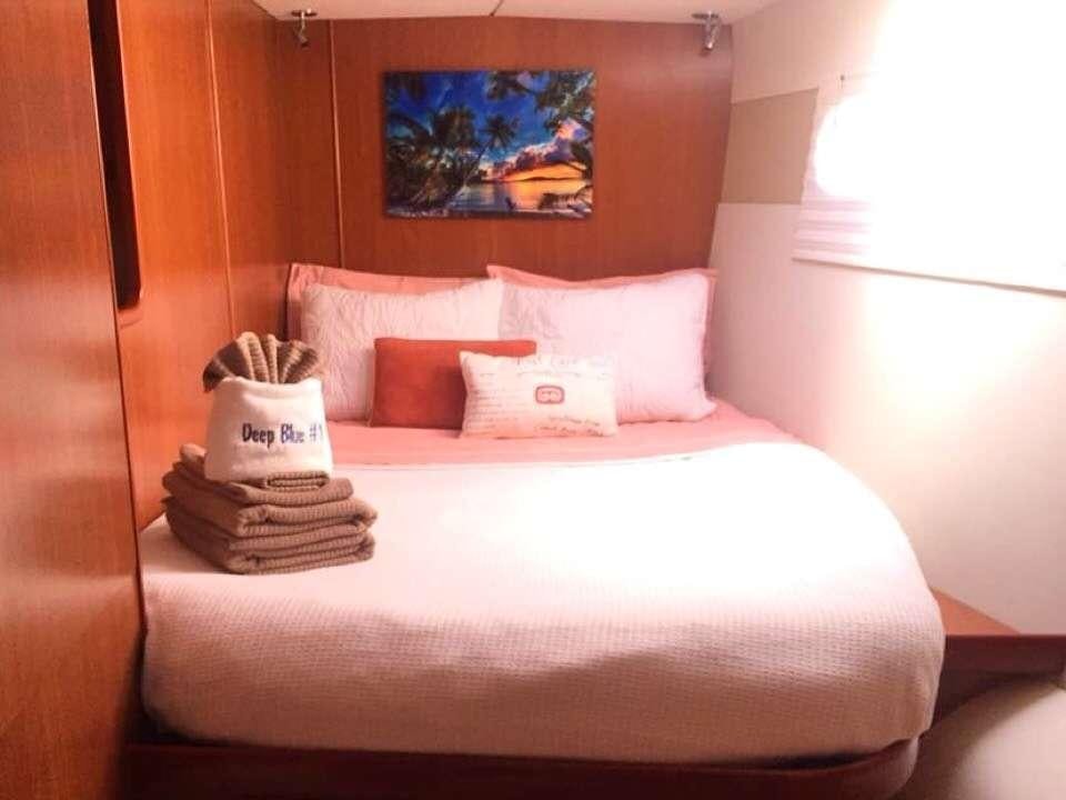 a bed with a tray of food on it aboard DEEPBLUE Yacht for Charter