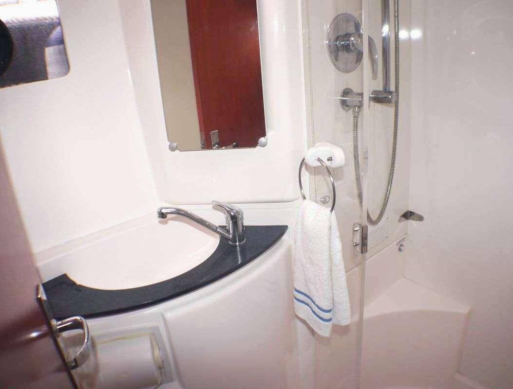 a bathroom with a bathtub sink and toilet aboard DEEPBLUE Yacht for Charter