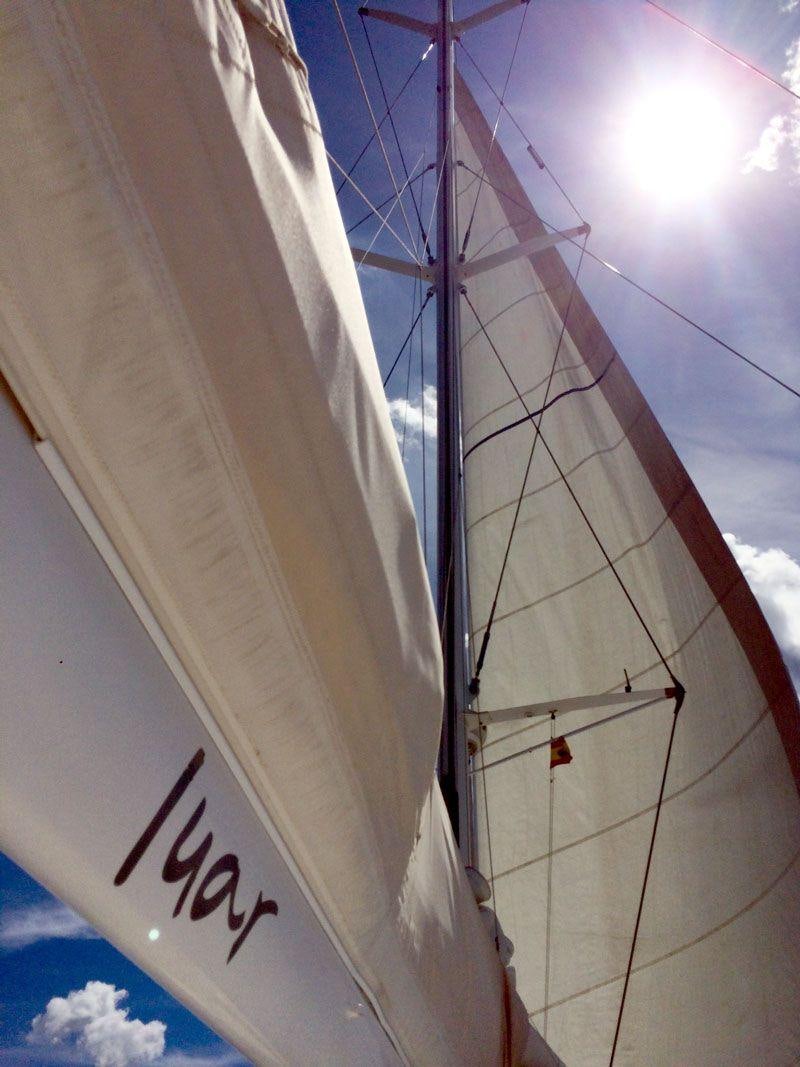 a sailboat with a white sail aboard LUAR Yacht for Charter