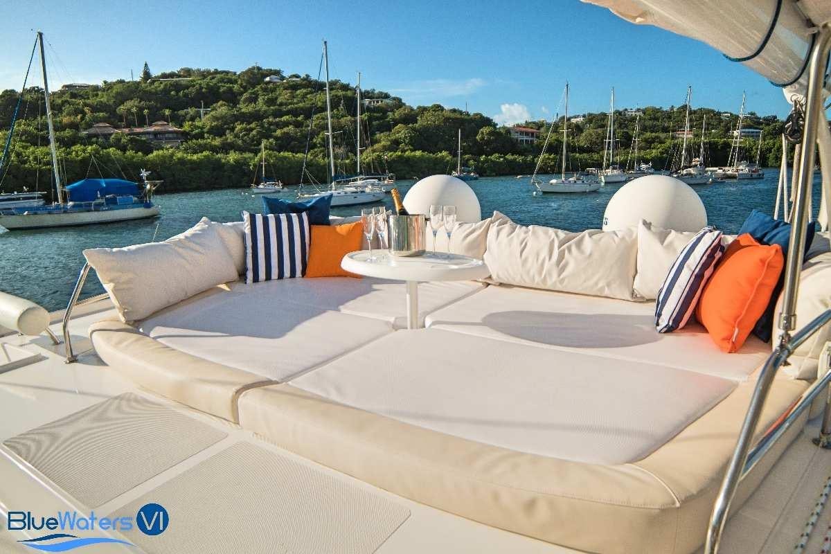 a boat with a white cover and orange and white pillows on it aboard LUAR Yacht for Charter