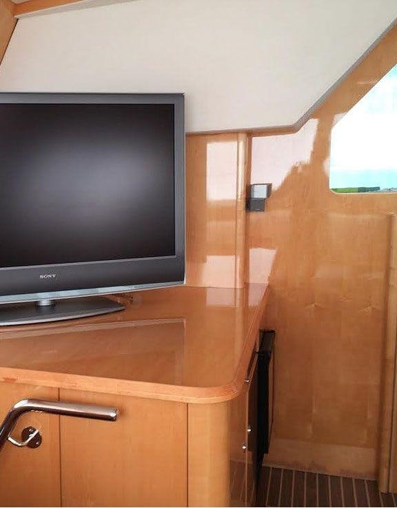 a tv on a cabinet aboard LUAR Yacht for Charter