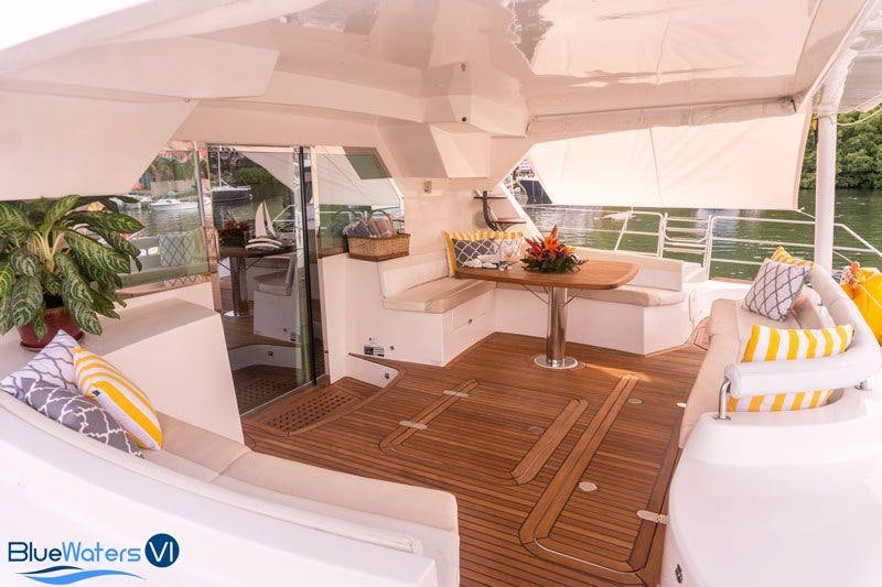 a room with a table and couches aboard LUAR Yacht for Charter