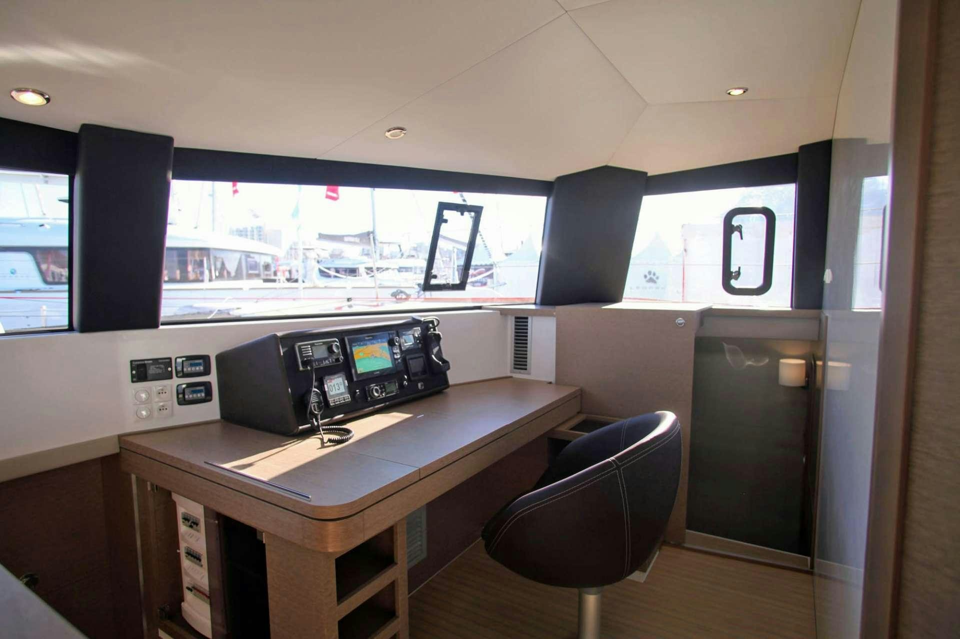 a room with a table and chairs aboard TRILOGY Yacht for Charter