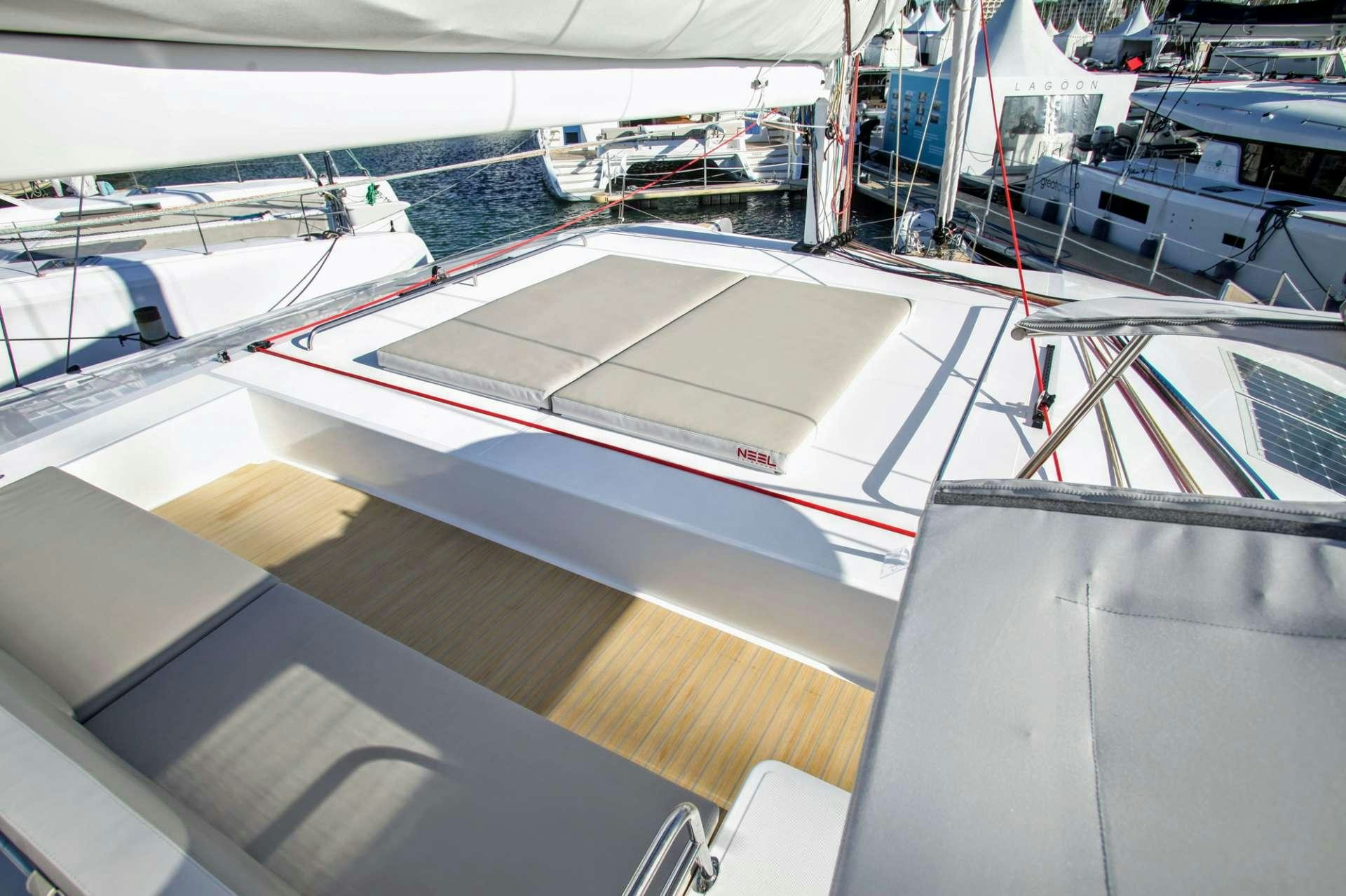 a large room with many white tables aboard TRILOGY Yacht for Charter