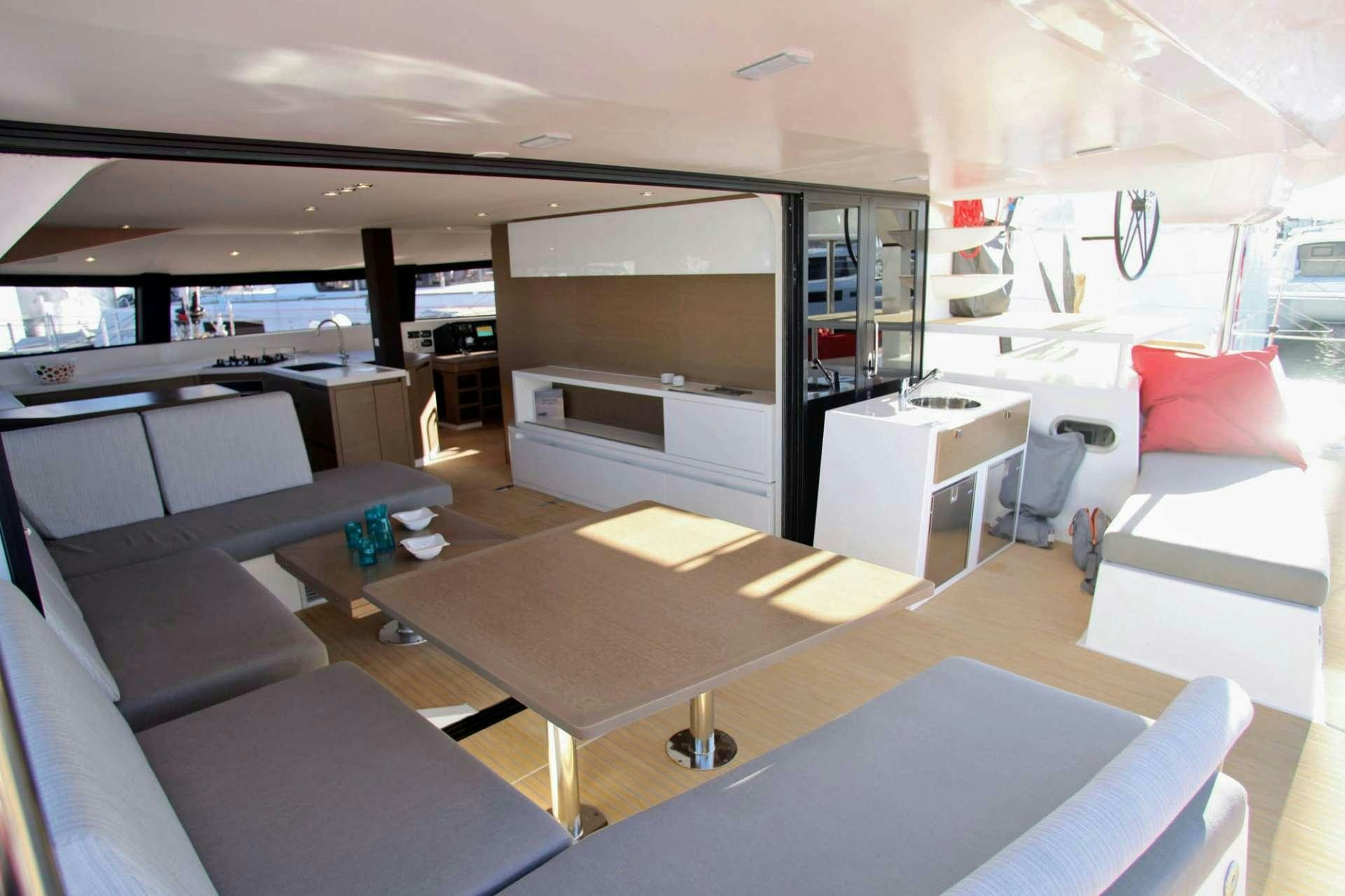 a room with a table and chairs aboard TRILOGY Yacht for Charter