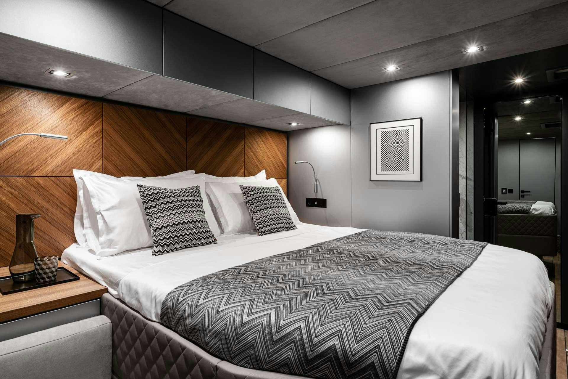 a bed with white sheets aboard E SUPERCAT Yacht for Charter