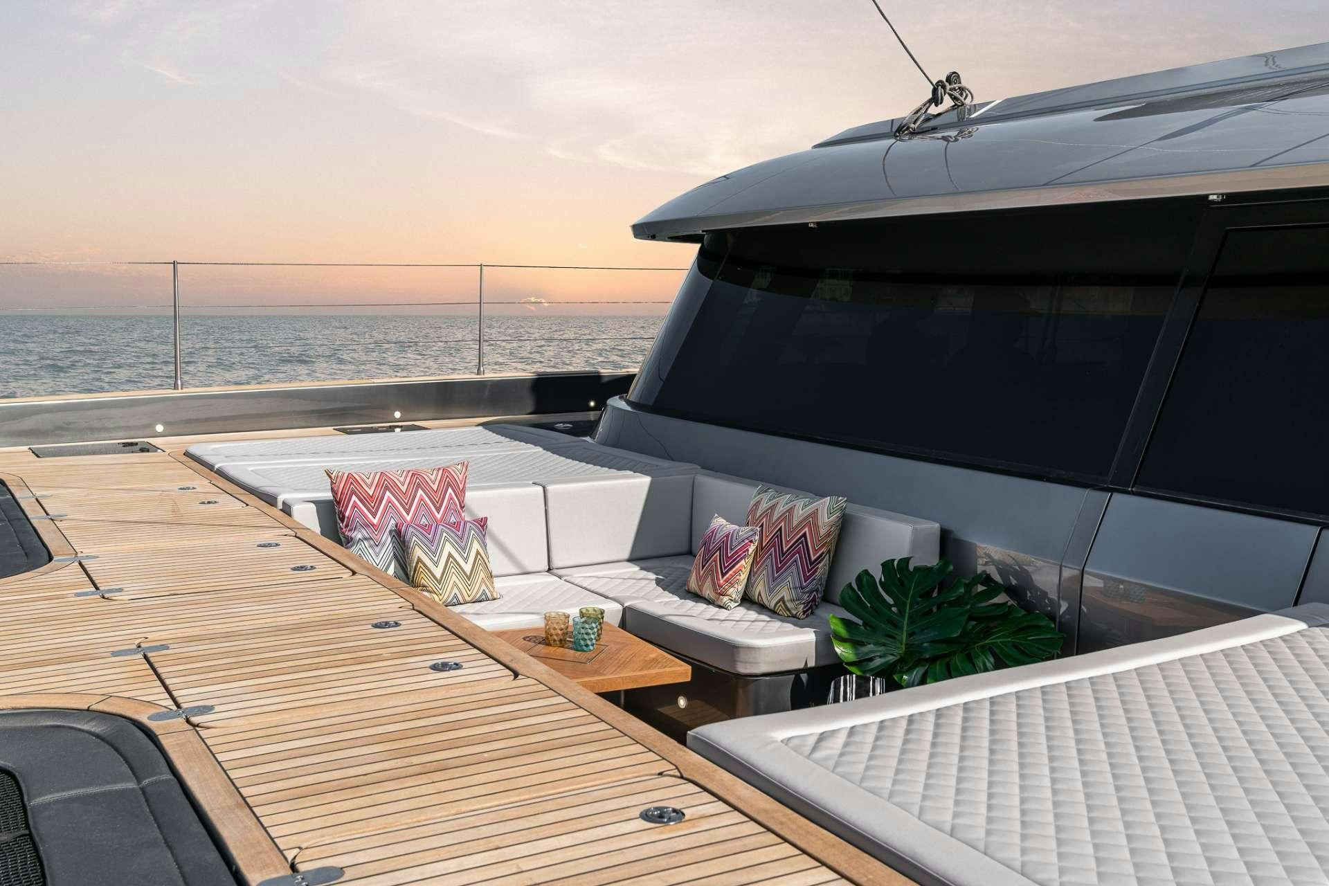a deck with a boat on it and a plant on the side aboard E SUPERCAT Yacht for Charter