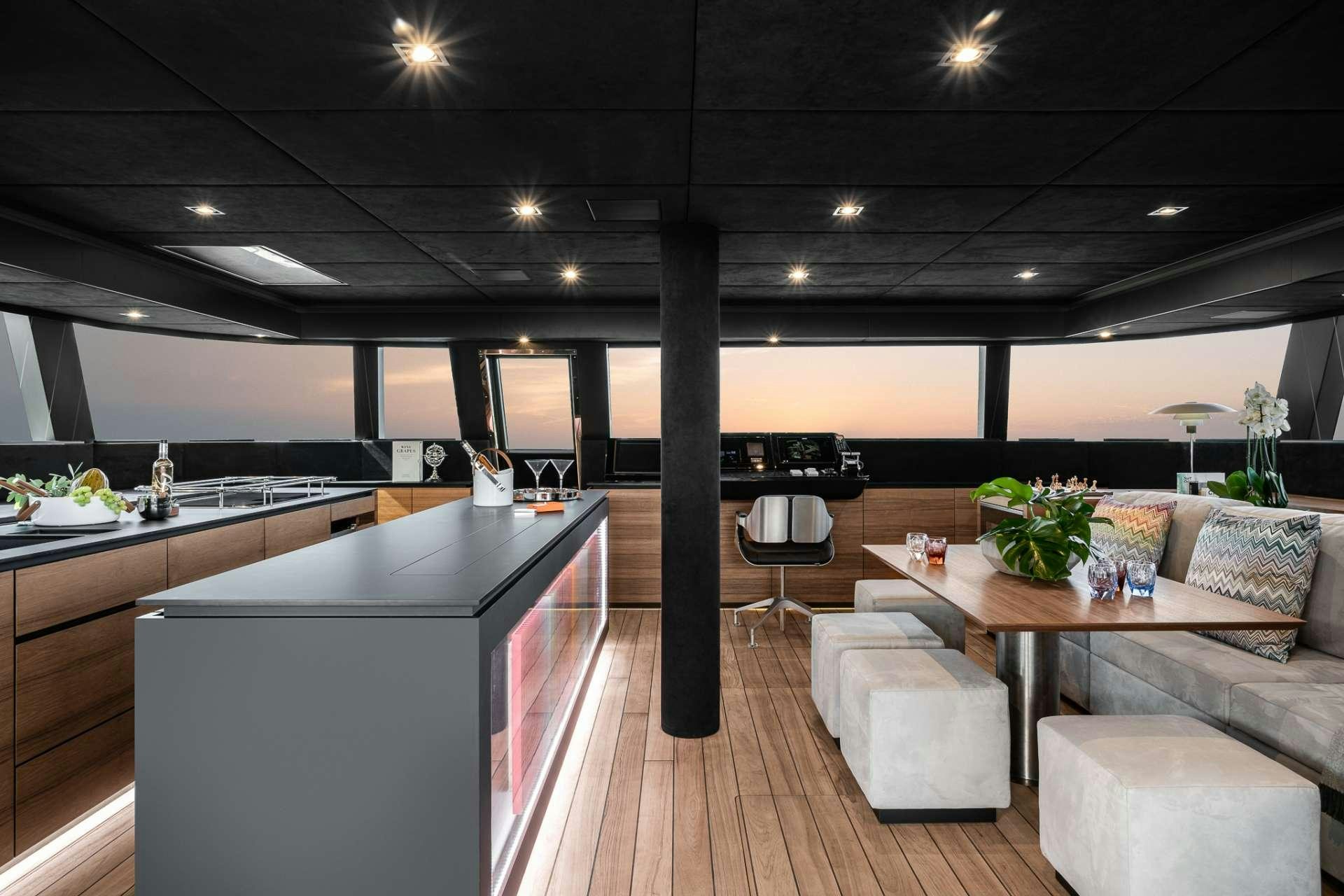a modern kitchen with a large island aboard E SUPERCAT Yacht for Charter