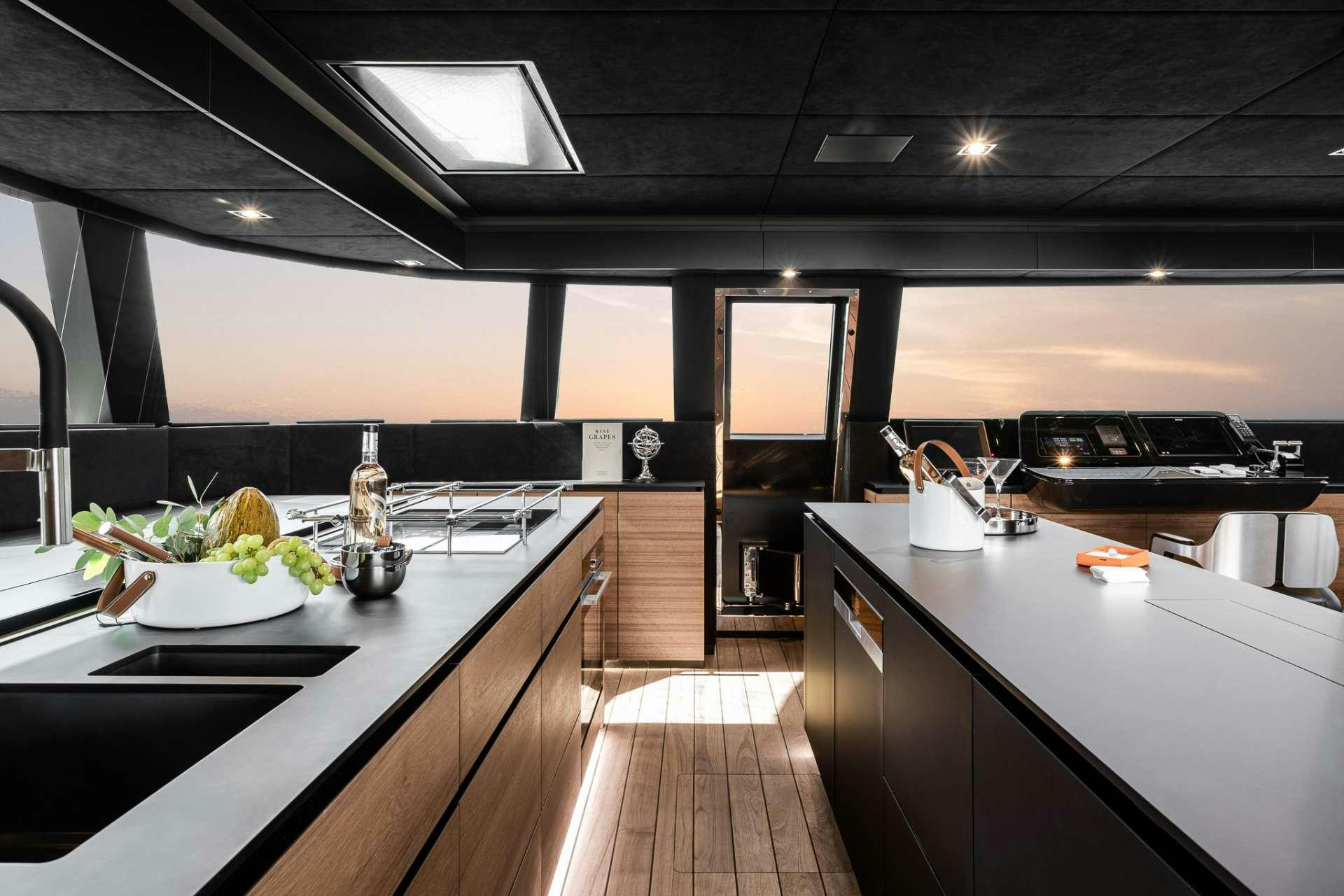 a kitchen with a large island aboard E SUPERCAT Yacht for Charter