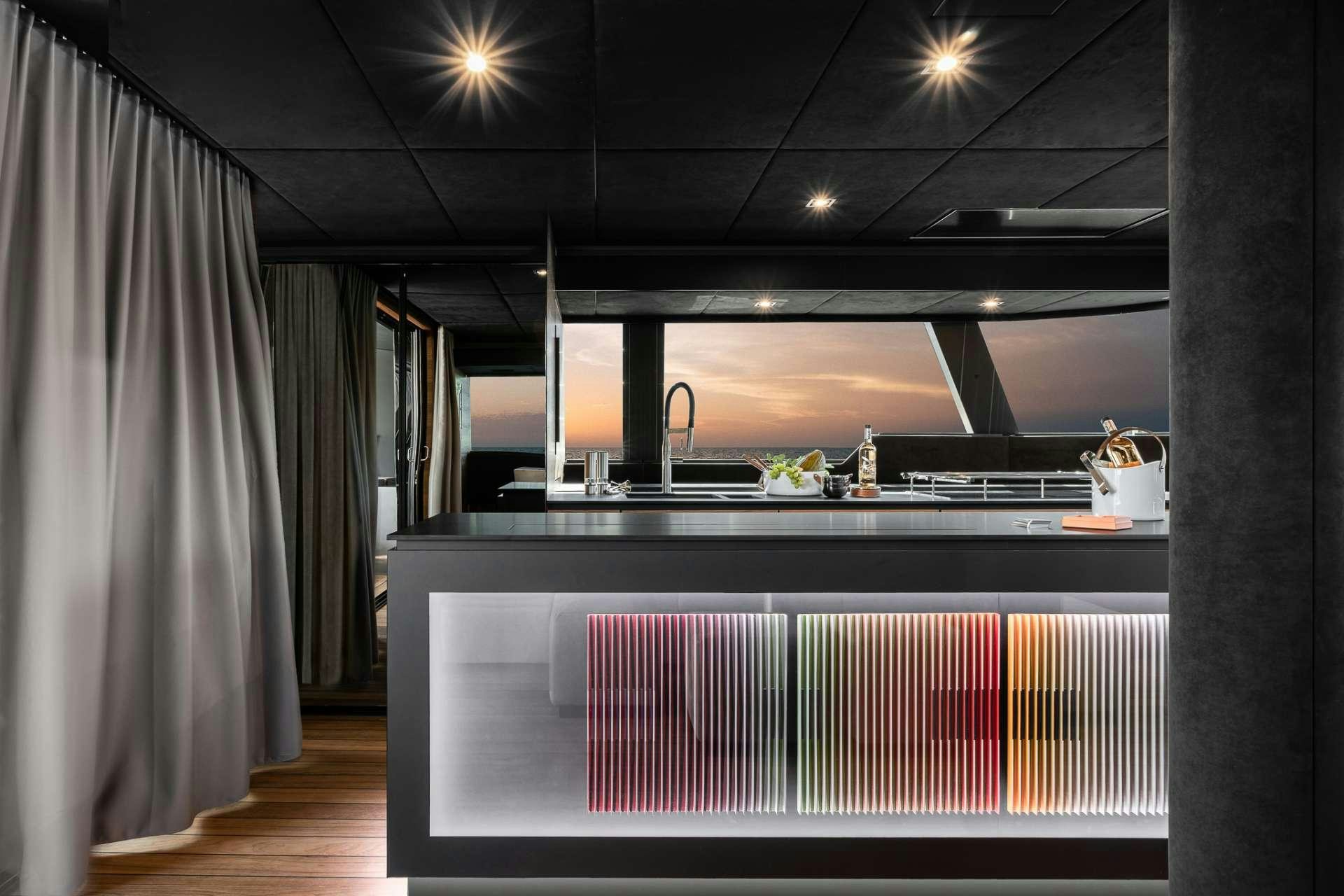 a kitchen with a large window aboard E SUPERCAT Yacht for Charter