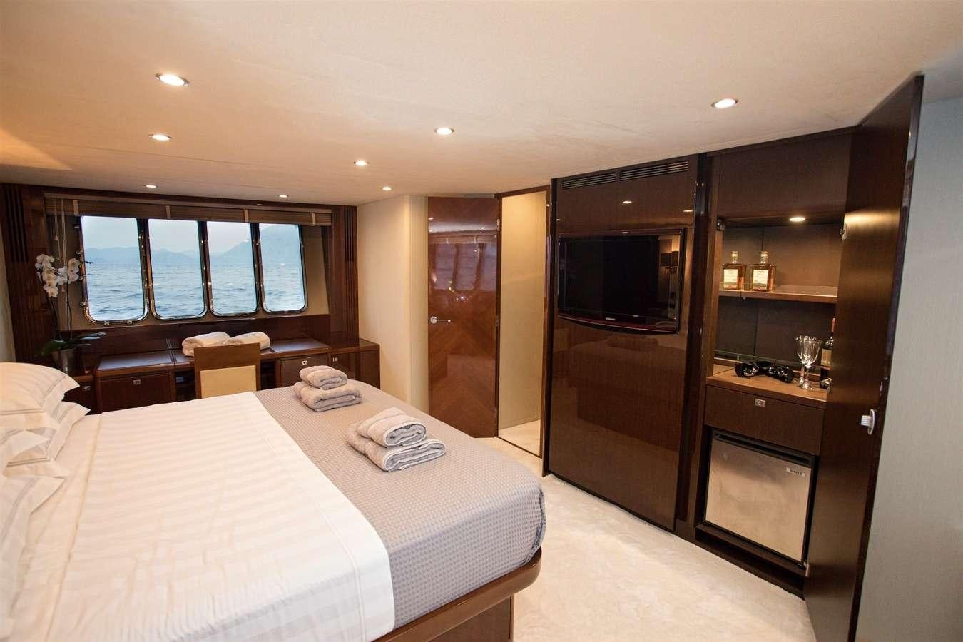 a hotel room with a bed and a tv aboard GIA SENA Yacht for Charter