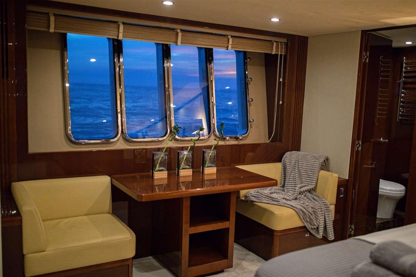 a room with a table and chairs aboard GIA SENA Yacht for Charter