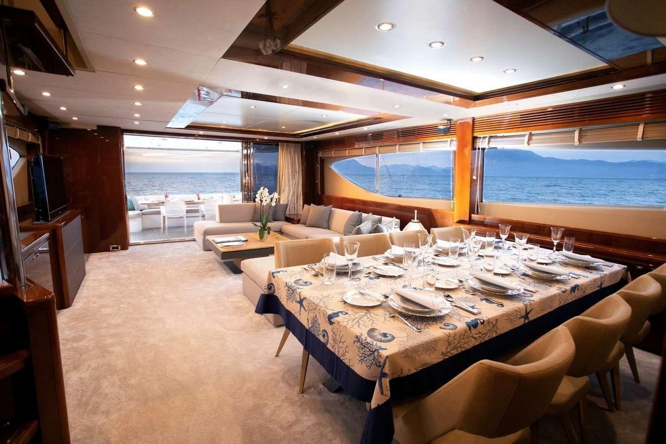 a room with a table and chairs aboard GIA SENA Yacht for Charter