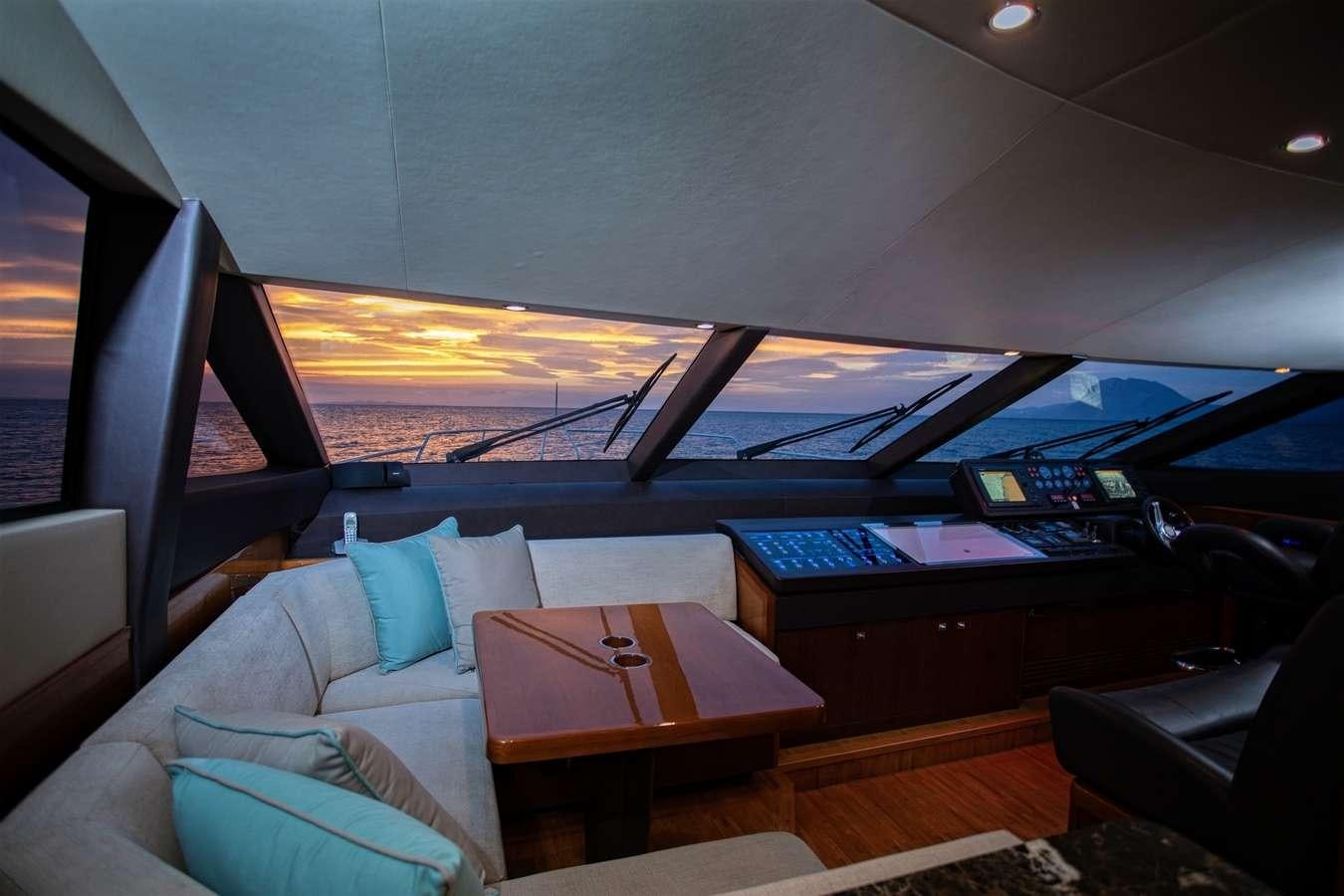 a room with a couch and a table with a laptop on it aboard GIA SENA Yacht for Charter