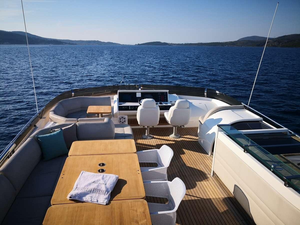a deck with chairs and tables on it next to a large body of water aboard GIA SENA Yacht for Charter