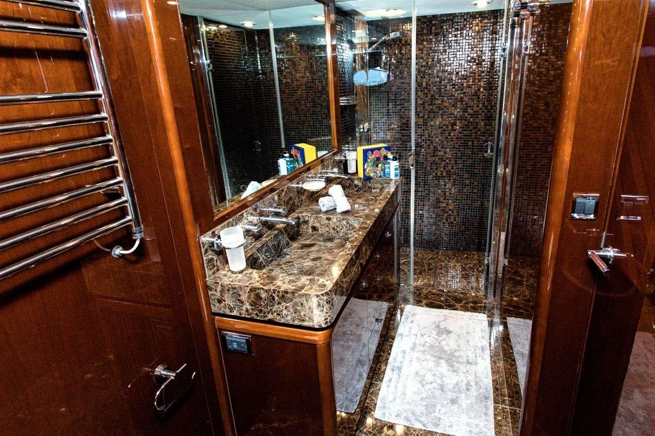 a bathroom with a countertop sink and a shower aboard GIA SENA Yacht for Charter