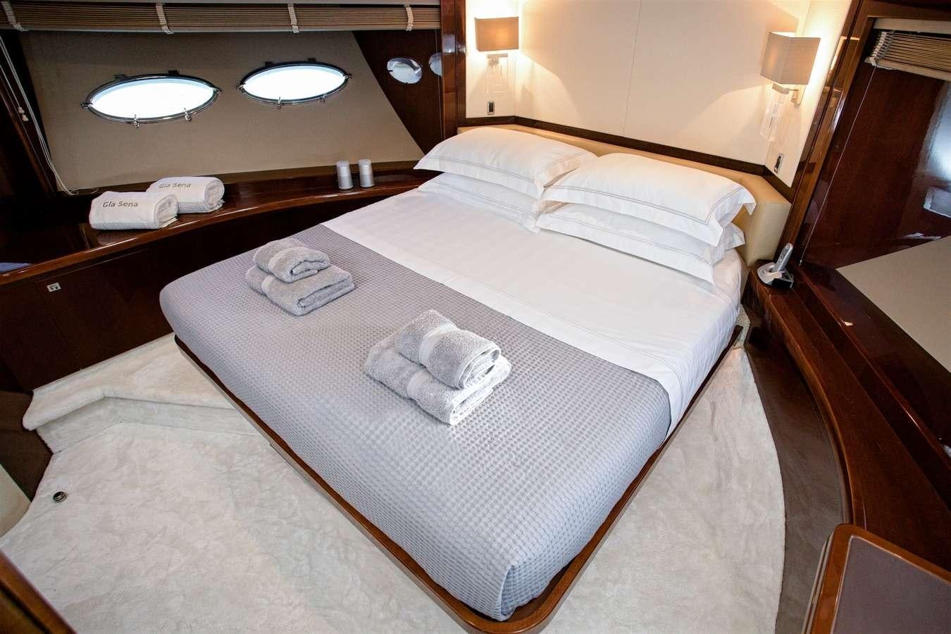 a hotel room with a large bed aboard GIA SENA Yacht for Charter