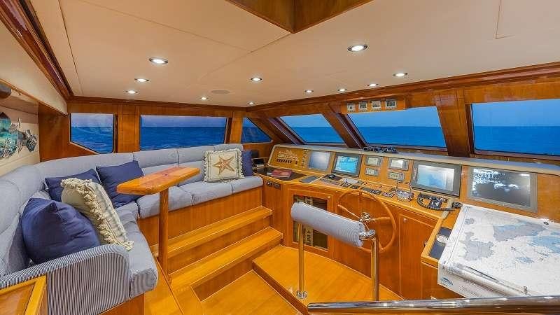 a room with a bed and a couch aboard HIGH RISE Yacht for Charter