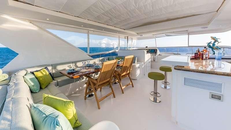 a room with a couch and chairs aboard HIGH RISE Yacht for Charter