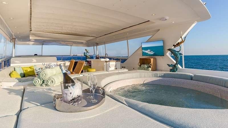 a room with a bed and a tv on the wall aboard HIGH RISE Yacht for Charter