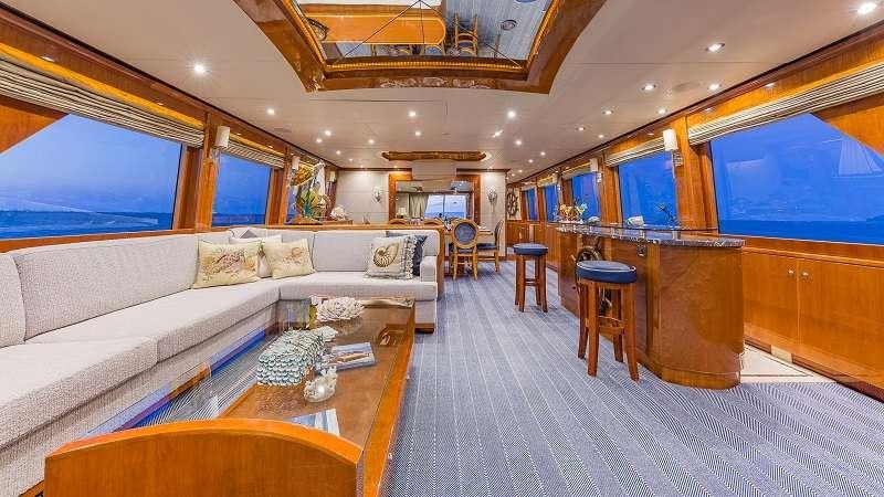 a living room with a couch and a table aboard HIGH RISE Yacht for Charter