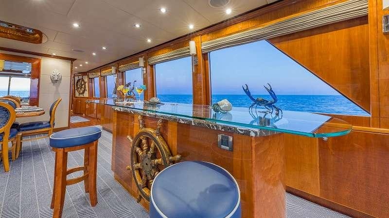 a bar with a bar and stools aboard HIGH RISE Yacht for Charter