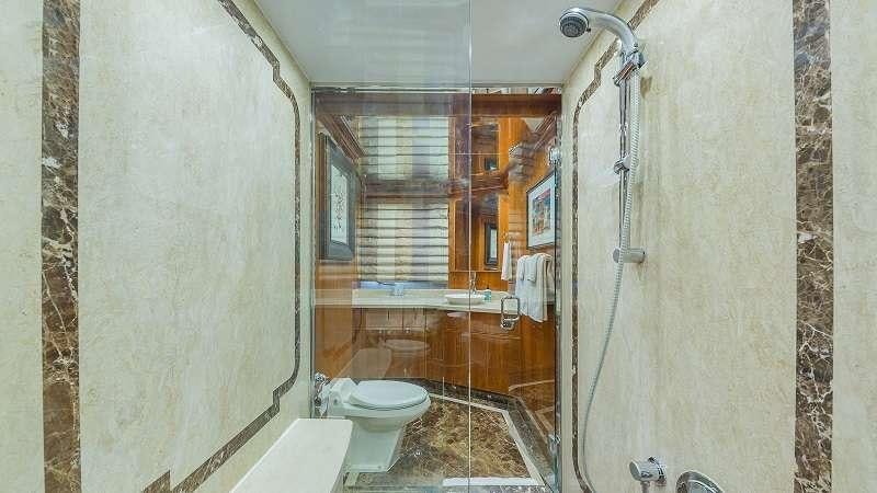 a bathroom with a toilet and a shower unit aboard HIGH RISE Yacht for Charter