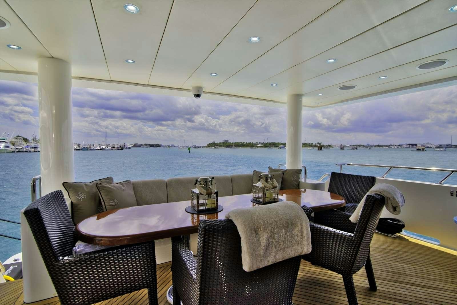a table and chairs on a deck aboard STERLING V Yacht for Charter