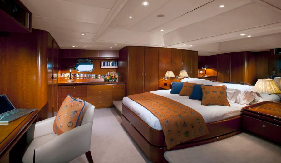 a bedroom with a bed and a desk aboard SEAQUELL Yacht for Charter