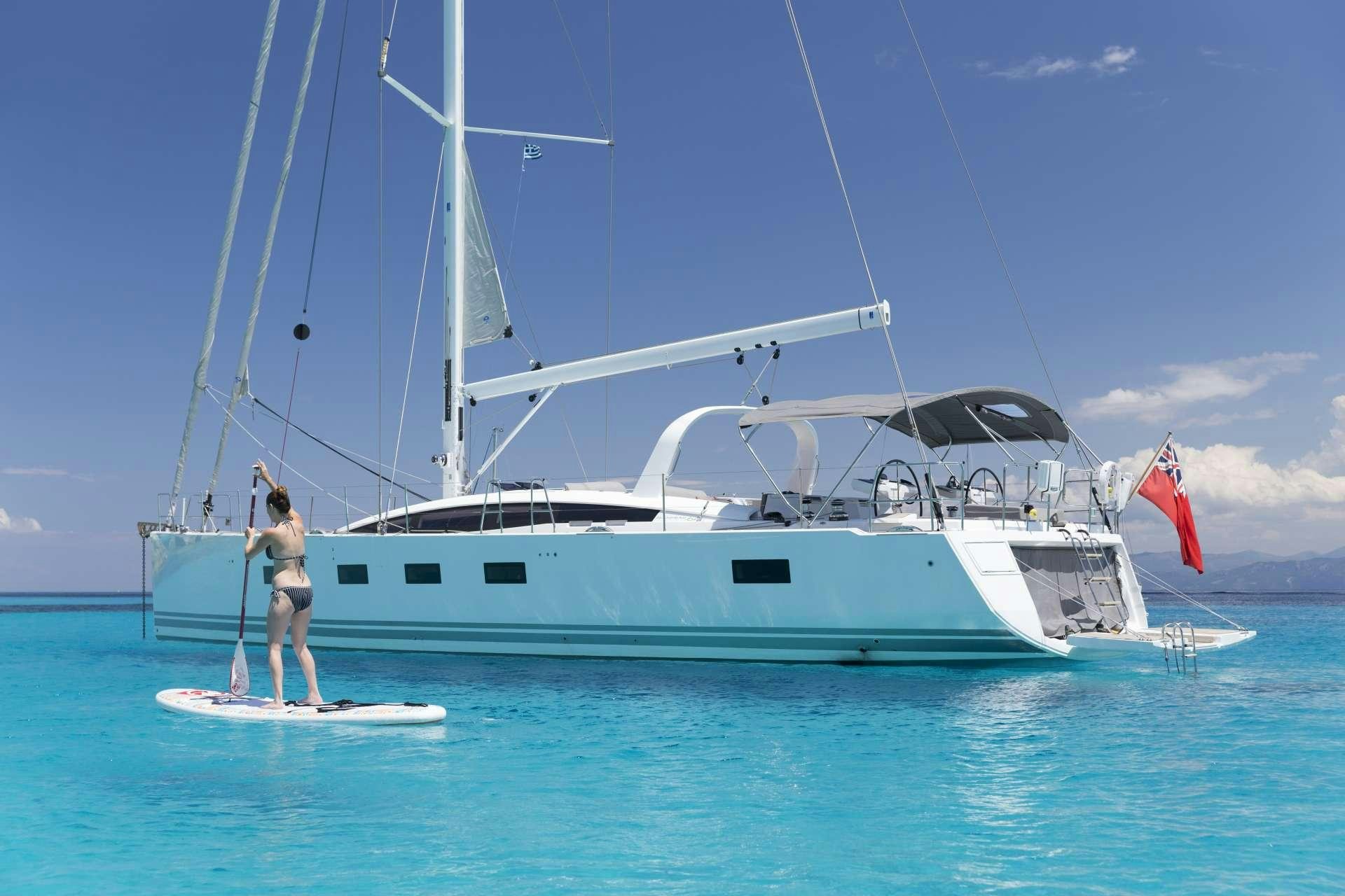 a person standing on a boat aboard JEANNEAU 64 Yacht for Charter