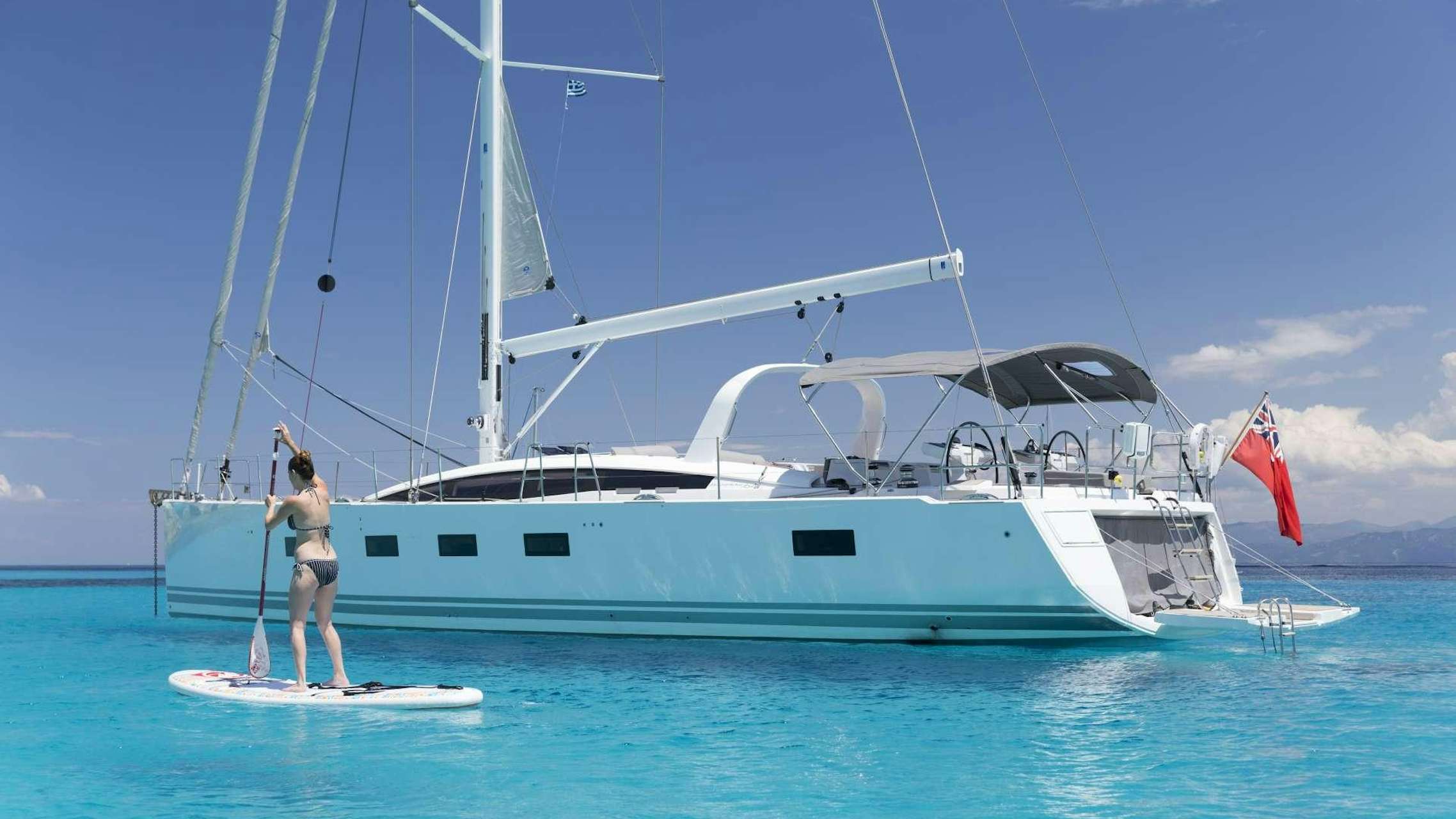 a person standing on a boat aboard JEANNEAU 64 Yacht for Charter