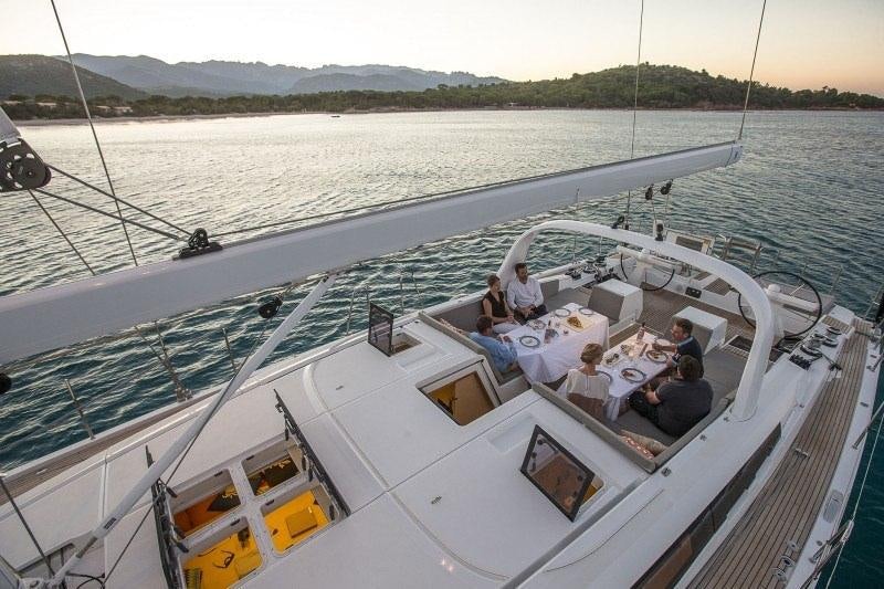 a group of people on a boat aboard JEANNEAU 64 Yacht for Charter