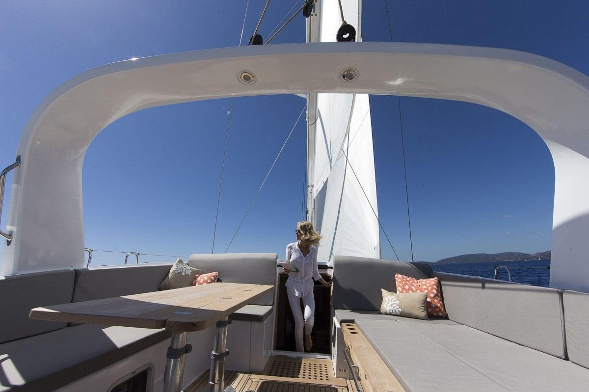 a person standing on a boat aboard JEANNEAU 64 Yacht for Charter