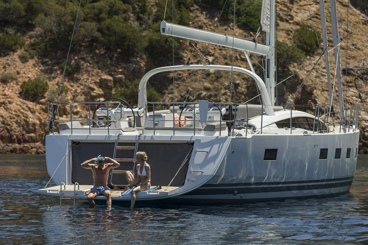 a couple of people on a boat aboard JEANNEAU 64 Yacht for Charter
