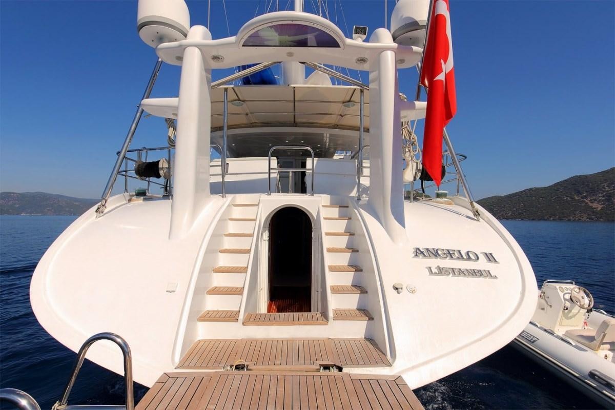 a white boat on a body of water aboard ANGELO II Yacht for Charter