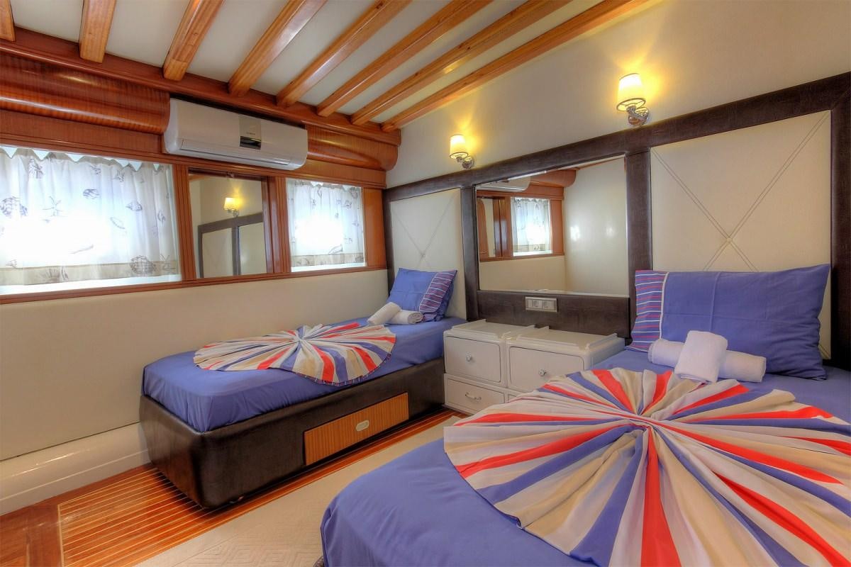 a couple of beds in a room aboard ANGELO II Yacht for Charter