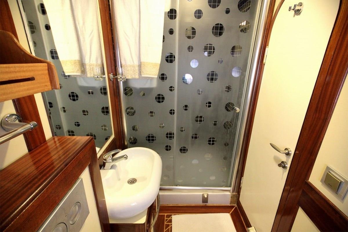 a bathroom with a sink and a shower aboard ANGELO II Yacht for Charter