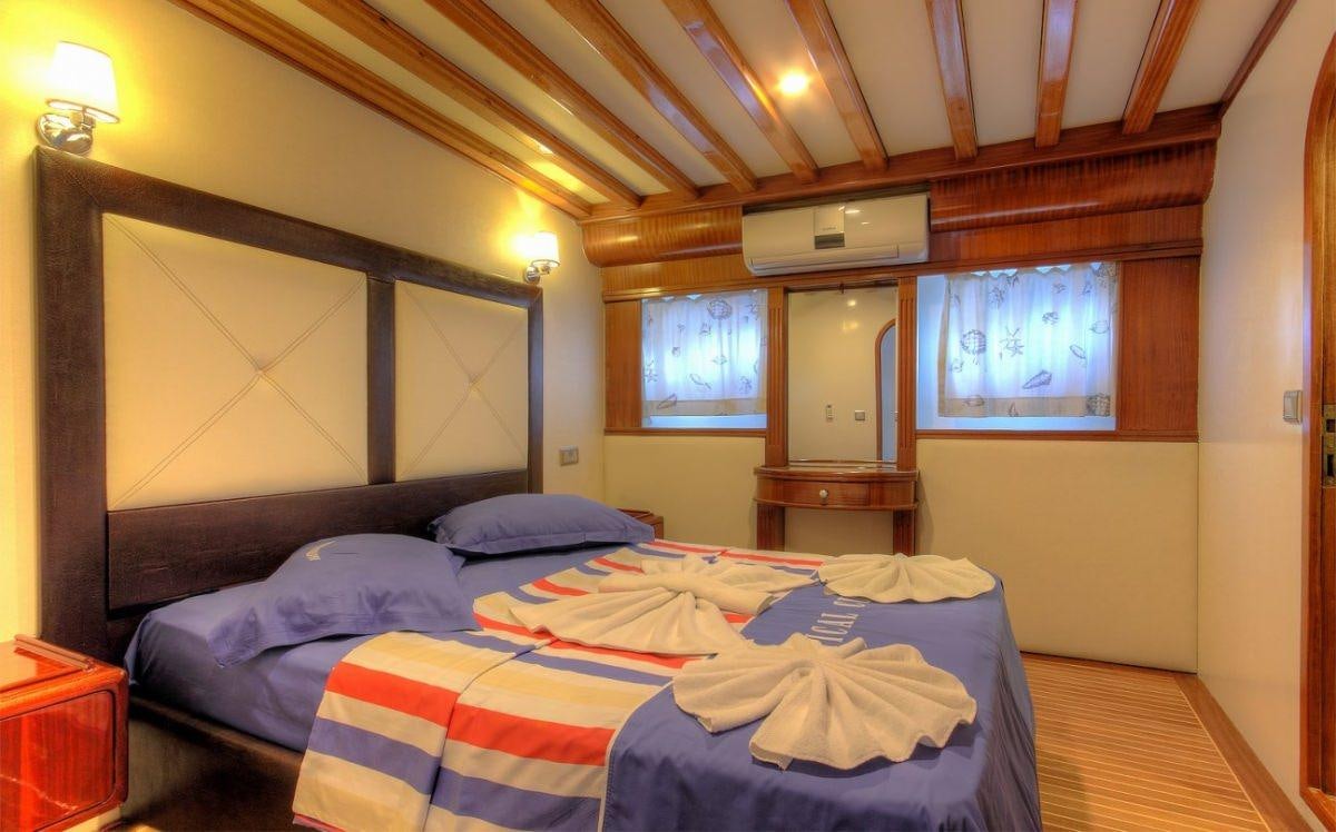 a bedroom with two beds aboard ANGELO II Yacht for Charter