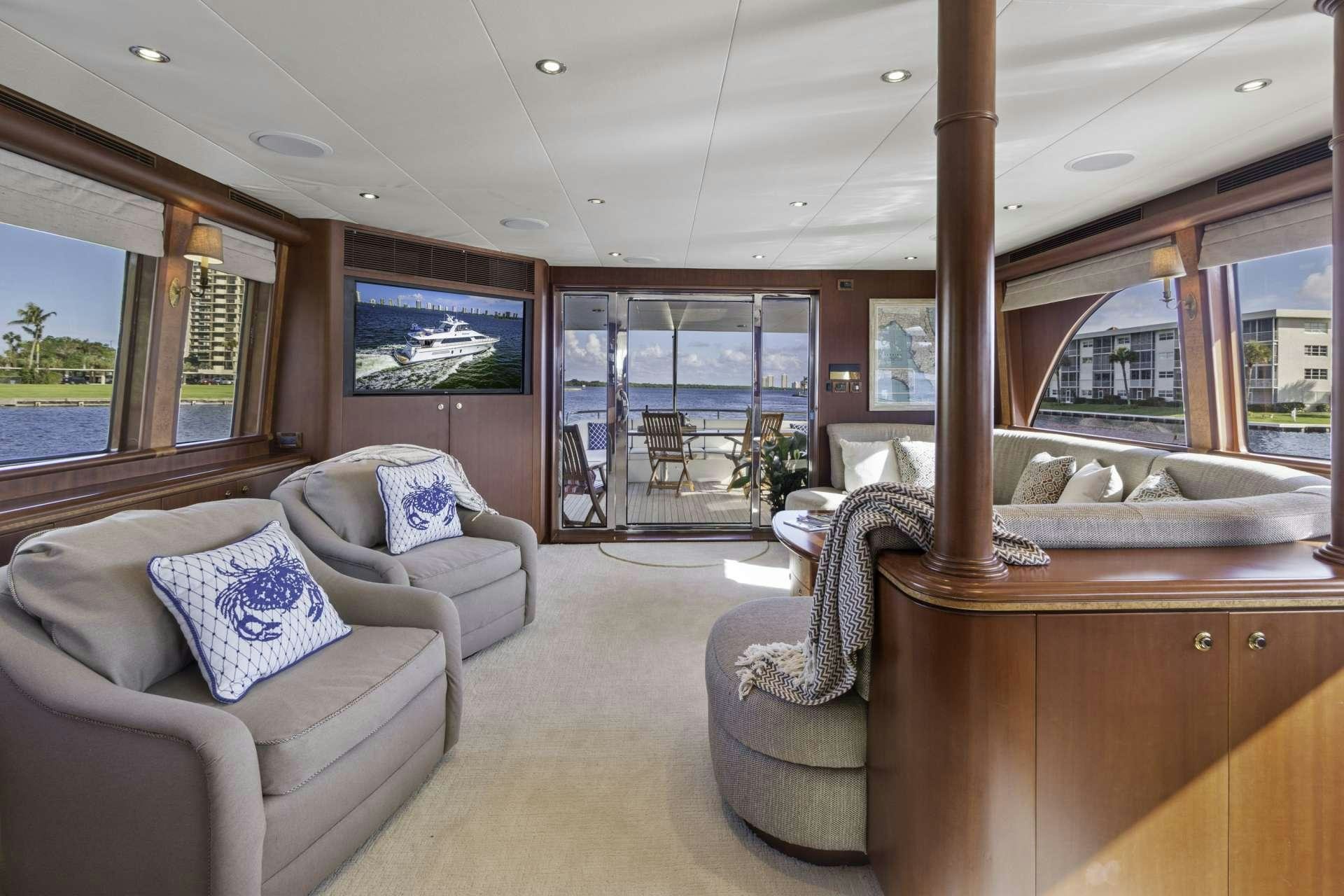 a living room with a large window aboard WINDWARD Yacht for Charter
