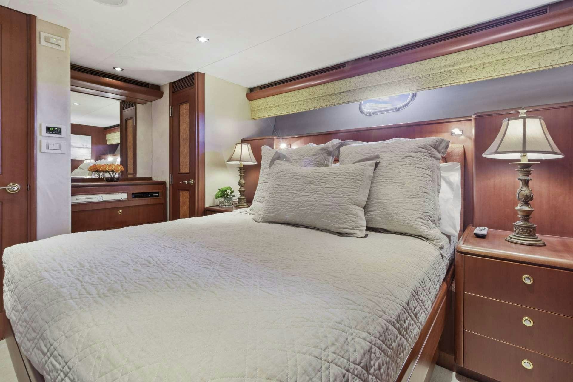 a bed with white sheets aboard WINDWARD Yacht for Charter