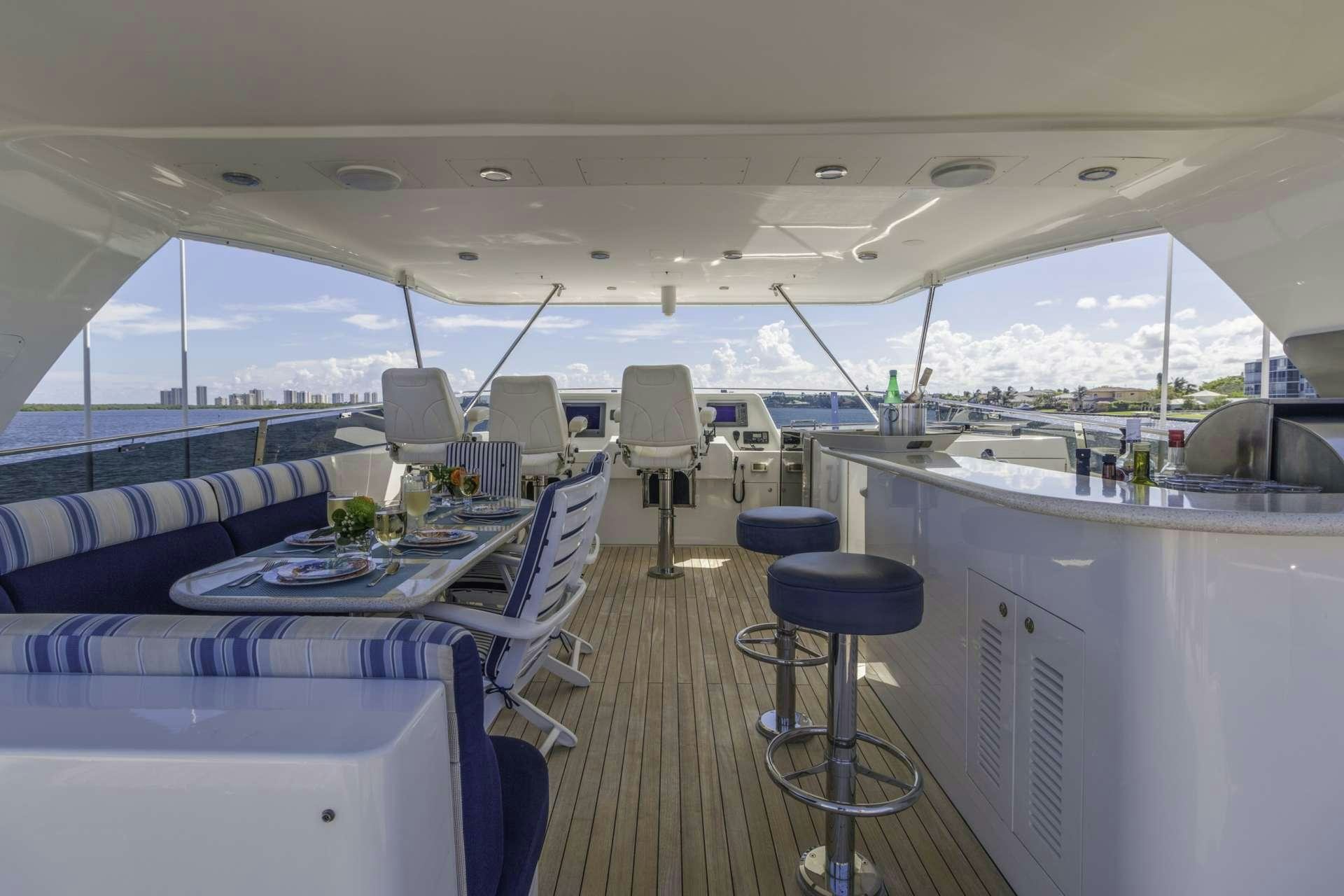 a boat with a table and chairs aboard WINDWARD Yacht for Charter