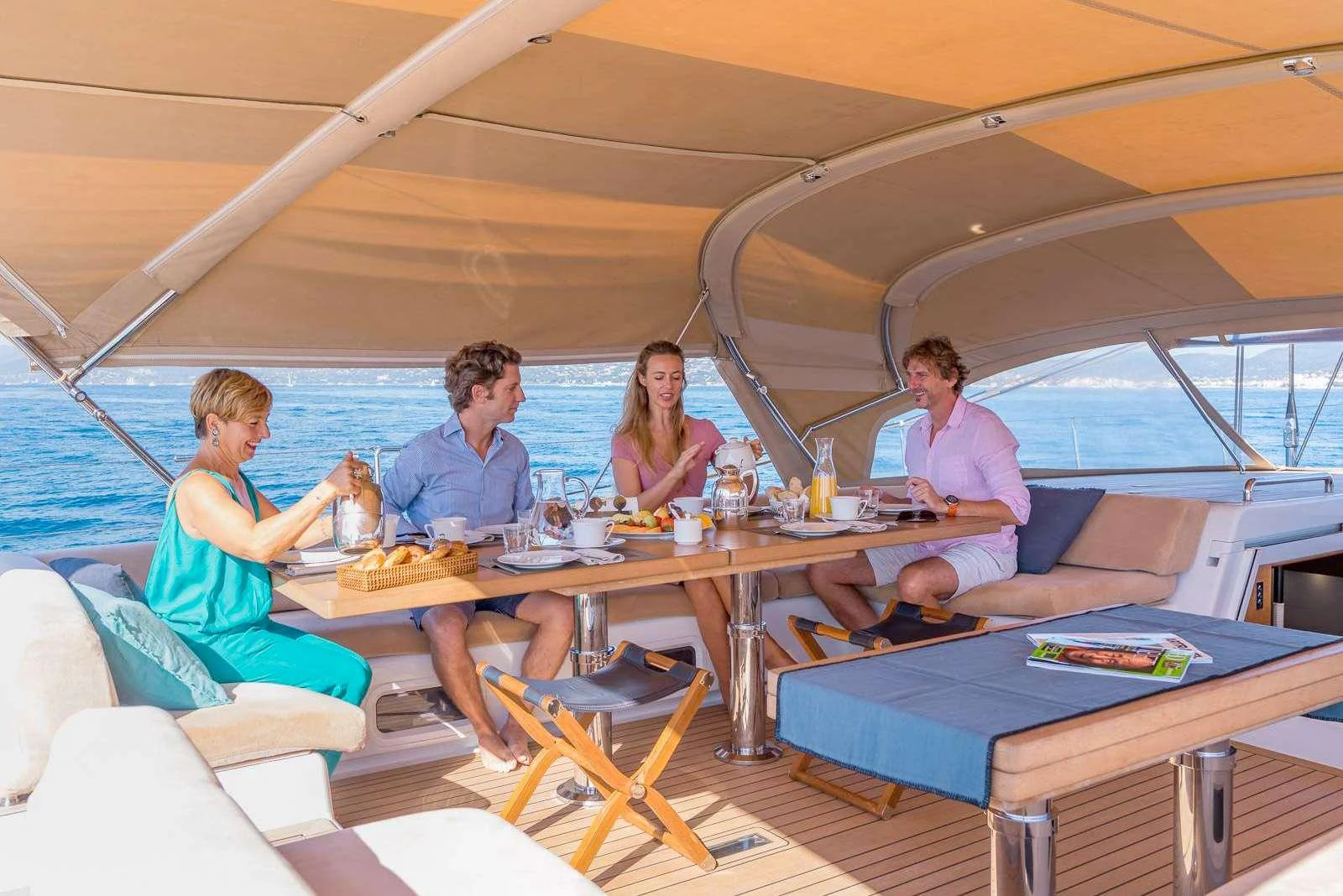 a group of people sitting at a table aboard THALIMA Yacht for Charter