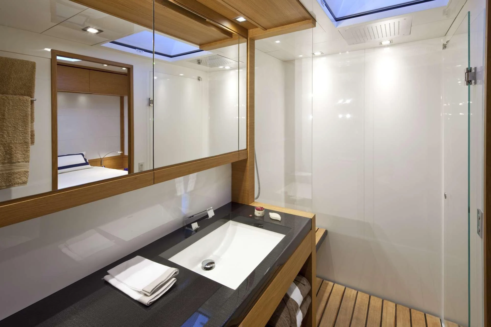 a bathroom with a sink and mirror aboard THALIMA Yacht for Charter