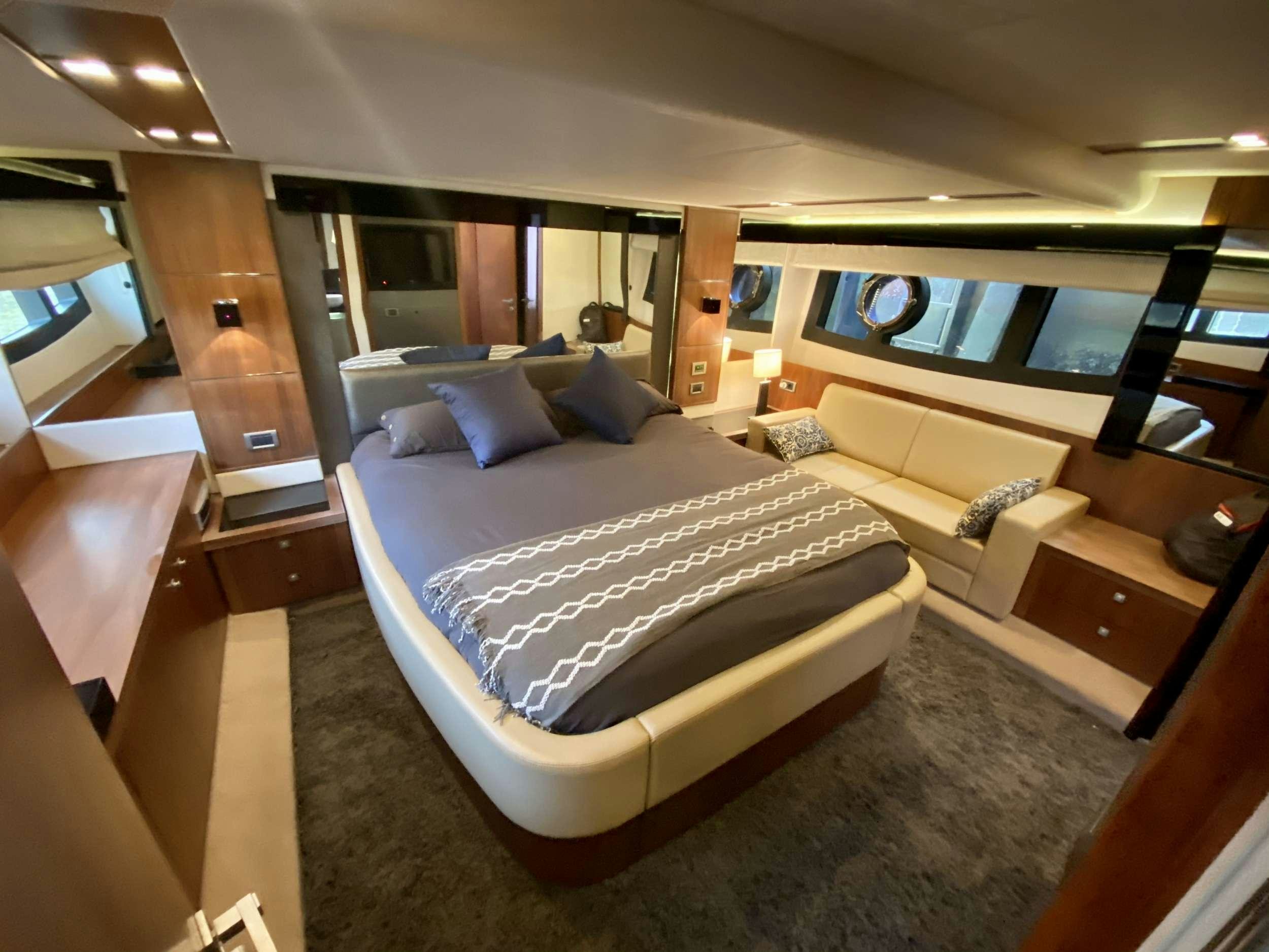 a room with a bed and a desk aboard ALMA Yacht for Charter