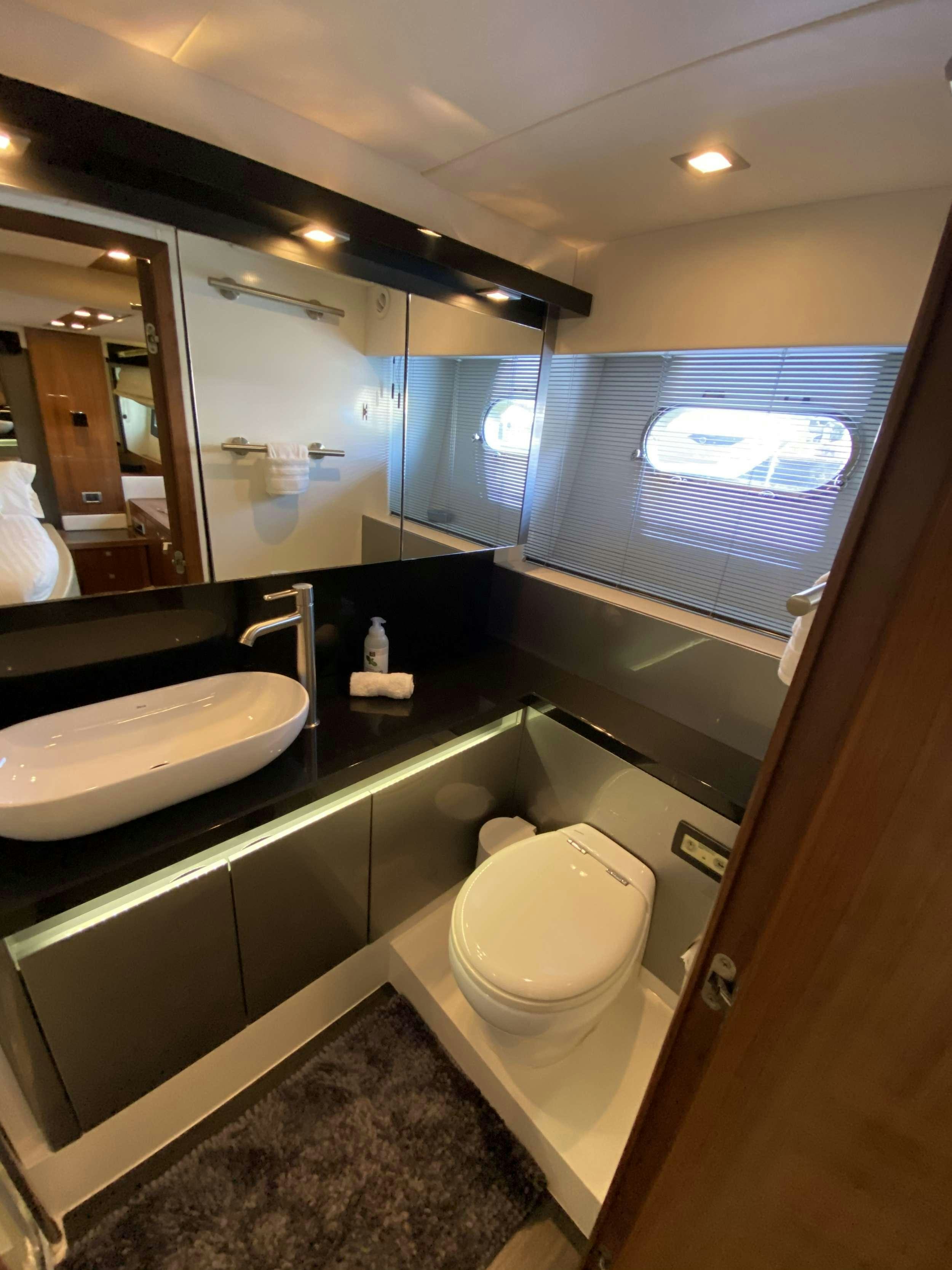 a bathroom with a large mirror aboard ALMA Yacht for Charter