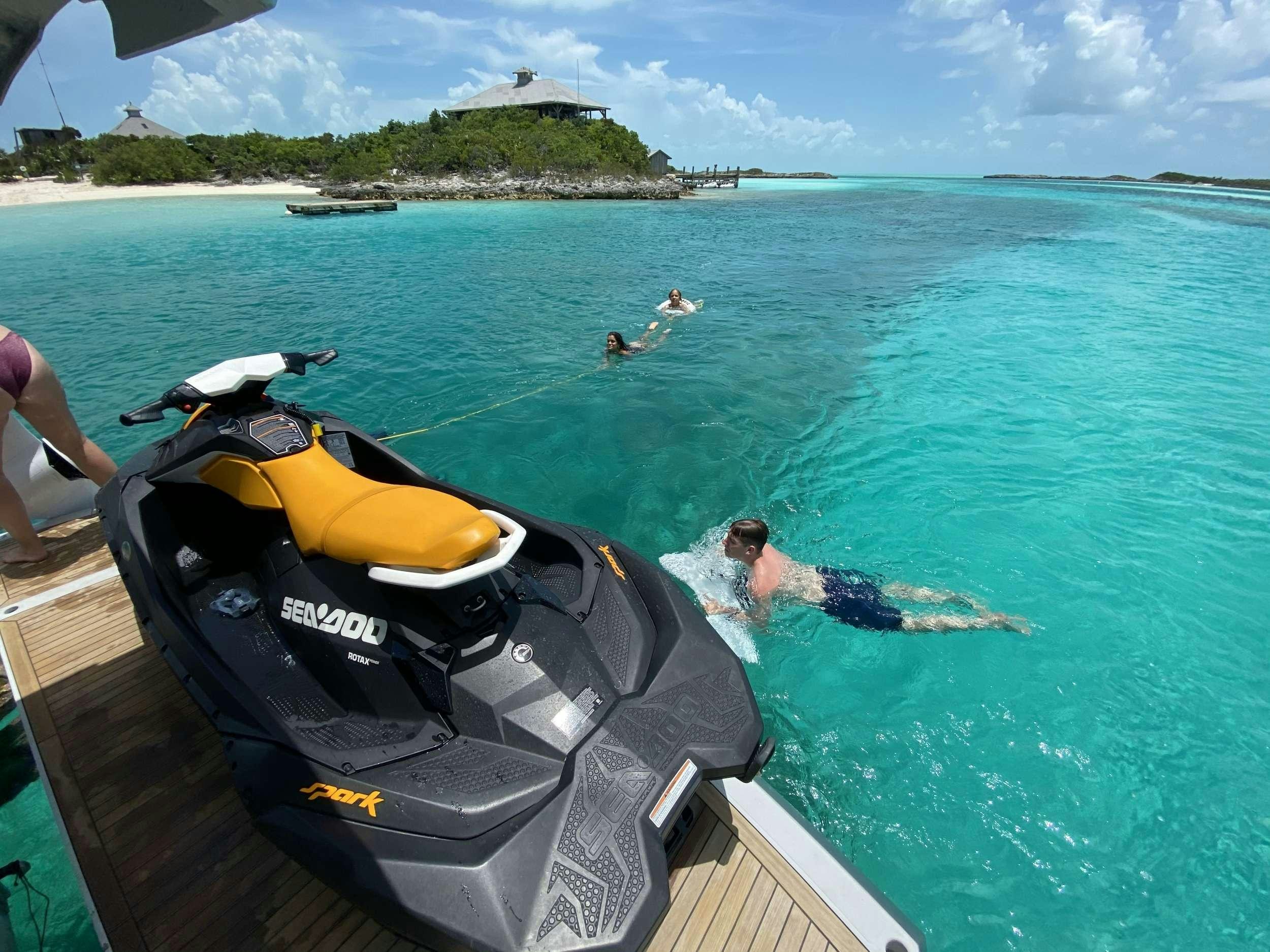 a person lying on a raft in the water aboard ALMA Yacht for Charter