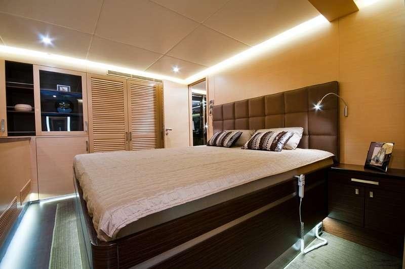 a bedroom with a bed and a desk aboard IPHARRA Yacht for Charter