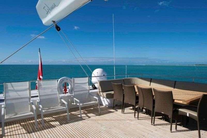 a deck with chairs and a plane aboard IPHARRA Yacht for Charter